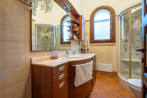 a bathroom with a sink and a shower at Tenuta del Normanno in Carovigno