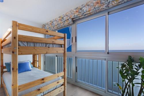 a bunk bed in a room with a large window at Milailea in Tacoronte