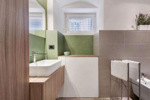a bathroom with a sink and a mirror at Gemhouse Smeraldo garda lake in Gargnano