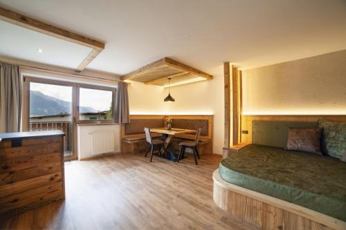 a bedroom with a bed and a desk and a table at Mühlanderhof Apt Endkopf in Resia