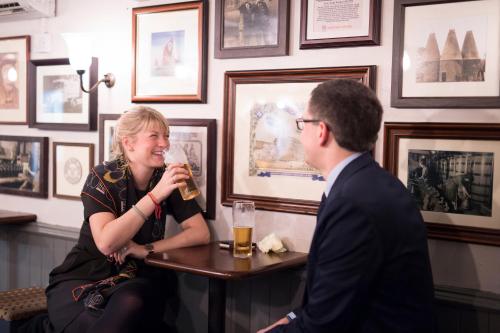 a man and a woman drinking beer in a bar at The Millers Arms Inn in Canterbury
