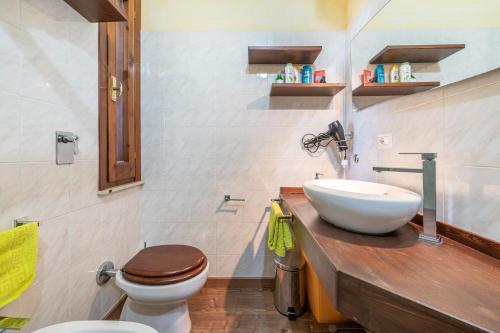 a bathroom with a white sink and a toilet at Solemarevacanze Villasimius in Villasimius