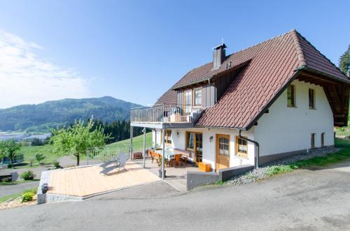 a white house with a deck and a balcony at Vordersbergerhof in Hausach