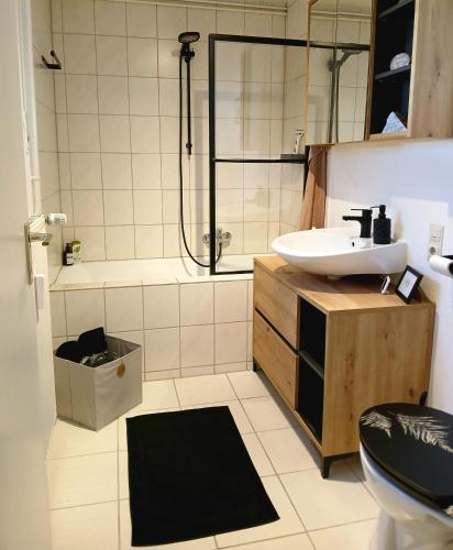 a bathroom with a sink and a toilet and a shower at Apartment Flora in Stockach