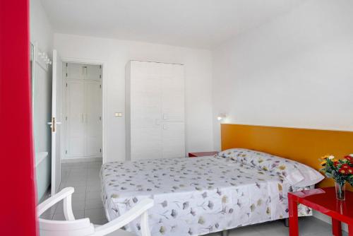 a bedroom with a bed and a red table at Silent Flat in Puerto Rico de Gran Canaria