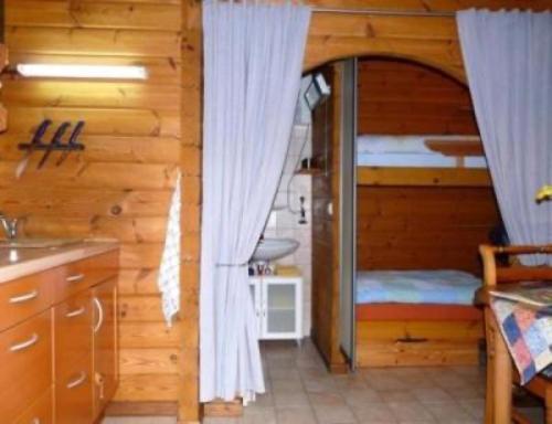 a kitchen with a room with a bed and a window at Privatzimmer R und C Lohnherr in Lehnin