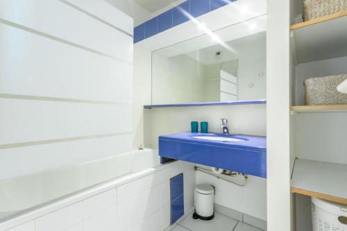 a bathroom with a blue sink and a mirror at Villa Alpaga Esterel Vue Mer in Saint-Raphaël