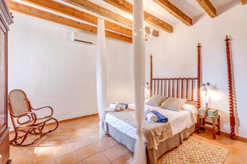 a bedroom with a bed and a chair in a room at Finca Buniferri in Llucmajor