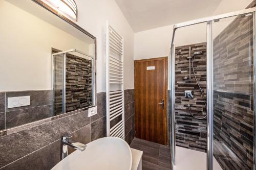 a bathroom with a shower and a sink at Appartamento Primavera 2 in Moena