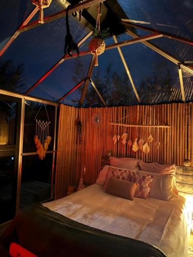 a bedroom with a bed in a tent at La Petite Maison De Noémie in Gras