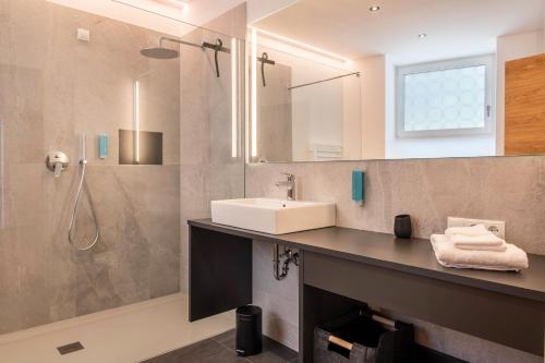 a bathroom with a sink and a shower at Luisl Hof - Apartment Herbae in Cornaiano