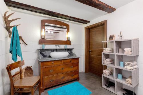 a bathroom with a sink and a wooden cabinet at Ferien auf der Fleischdielte in Mühlenbach