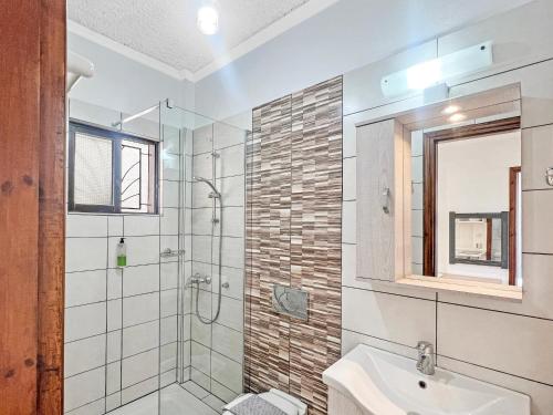 a bathroom with a shower and a sink at Andromaches large apartment 2 in Corfu