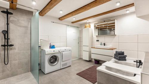 a bathroom with a washing machine and a sink at Ferienwohnung Haas in Bräunlingen