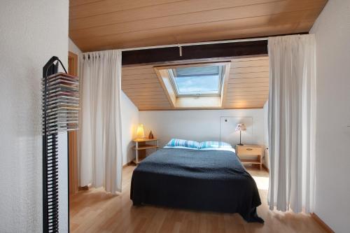 a bedroom with a bed in a room with a window at Ferienwohnung Thelen in Wallbach