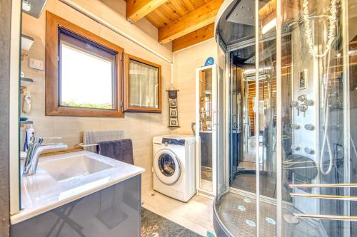 a bathroom with a sink and a washing machine at Maison Les Pieds Dans L'eau in Le Verdon-sur-Mer