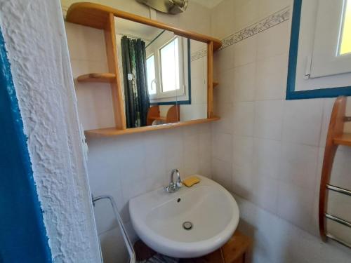 a bathroom with a sink and a mirror at Le paradis de Marie in Treignac