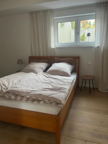 a bedroom with a large bed with a window at Feigental in Überlingen