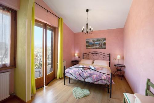 a bedroom with a bed and a large window at Villa Gaia in Bordighera