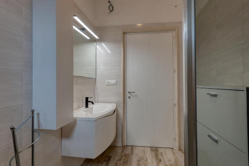 a bathroom with a white toilet and a sink at Anghelos in Lizzanello