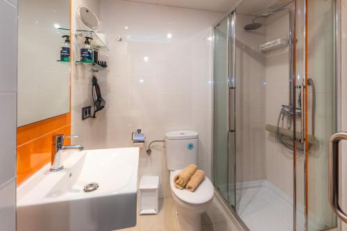 a bathroom with a sink and a toilet and a shower at Brillant in Cala Ratjada