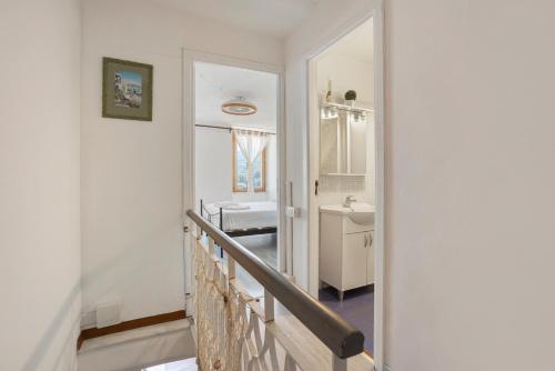 a hallway with a bathroom with a sink and a mirror at La ca bela in Portovenere