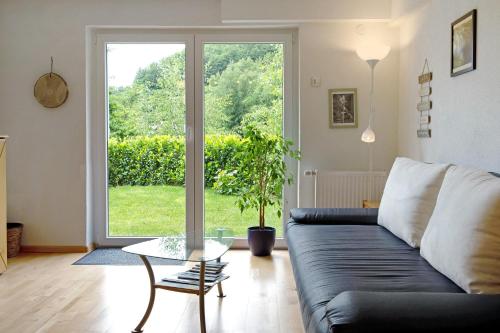 a living room with a couch and a glass table at Haus Marion in Todtnau