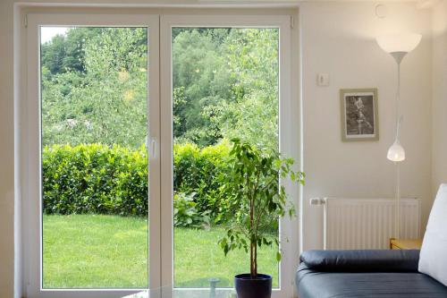 a living room with a sliding glass door at Haus Marion in Todtnau