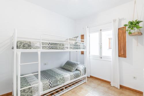 a room with two bunk beds and a window at Can Tosca in Jávea