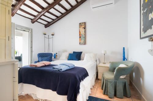 a bedroom with a bed and a chair at Preciosa Casa el Pedroso in El Pedroso