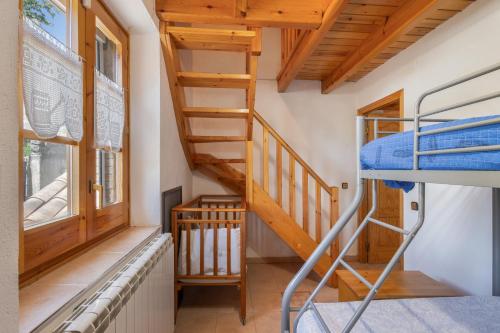 a room with a bunk bed and a staircase at Hospitalillo in Sant Corneli de Cercs 