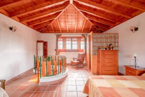 a bedroom with a bed and a wooden ceiling at Villa Padial in Torrox