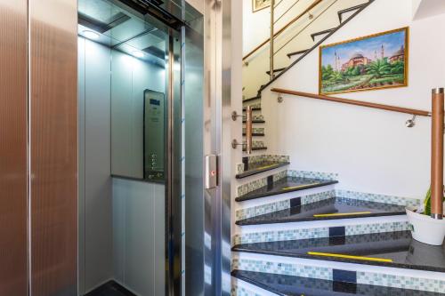 a stairwell with blue and white tile stairs at The Amphora Lodging in Furci Siculo