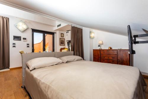 a bedroom with a large bed and a dresser at The Amphora Lodging in Furci Siculo