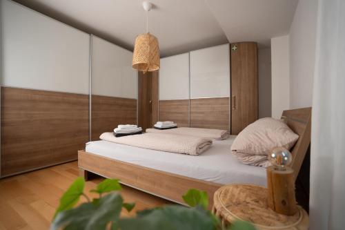 a bedroom with a bed with a mirror at Lo Ferienwohnung in Friedrichshafen