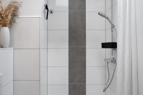 a bathroom with a shower with a shower curtain at Deichblick - in 5 min am Meer in Wangerland