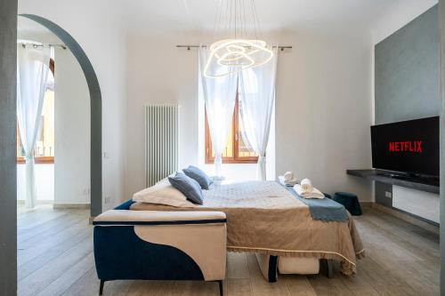 a bedroom with a bed in a room with a tv at La Domus Firenze in Florence
