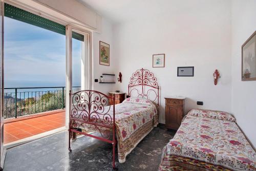 a bedroom with a bed and a balcony at Uliveto in Camogli