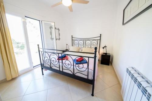 a bedroom with a bed in a room with a window at Ponent in Port de Soller