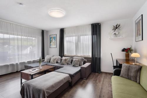 a living room with a couch and a table at Ferienwohnung Zum Hasen in Meschede