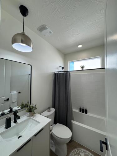 a bathroom with a toilet and a sink and a mirror at New Casita by Zion National Park and Saint George in Hurricane