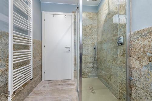 a bathroom with a shower with a glass door at Abaye 2 Pinot - Charm Adults Only in Soiano del Lago