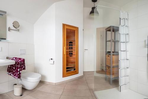 a bathroom with a toilet and a glass shower at Fewo Ostseeflair by Seeblick Ferien in Kappeln