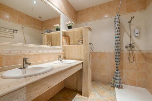 a bathroom with two sinks and a shower at Can León in Almodóvar del Río