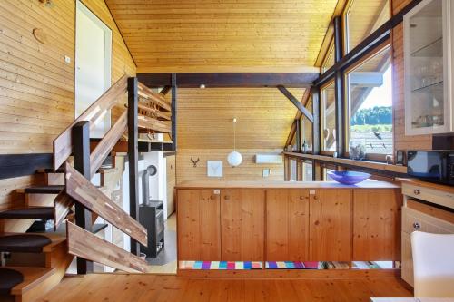 a room with wooden walls and a staircase in a house at Ferienhaus 10 Rechbergblick in Bernau im Schwarzwald