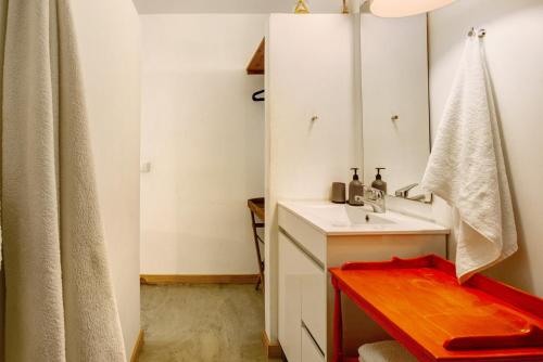 a bathroom with a sink and a mirror at Calheta Beach House T2 in Calheta