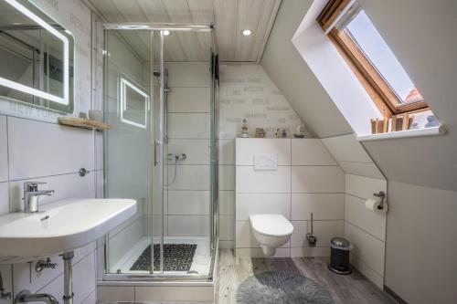 a bathroom with a shower and a sink and a toilet at Ankerplatz Maria Ratekau in Ratekau