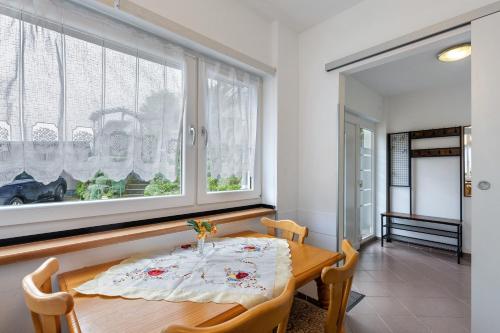 a dining room with a table and two windows at Ferienhaus Günther in Werder