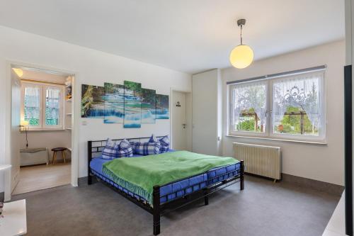 a bedroom with a bed in a room with windows at Ferienhaus Günther in Werder