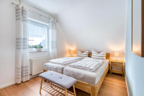 a bedroom with a bed and a chair and a window at Ferienwohnung Langenhorst in Raesfeld